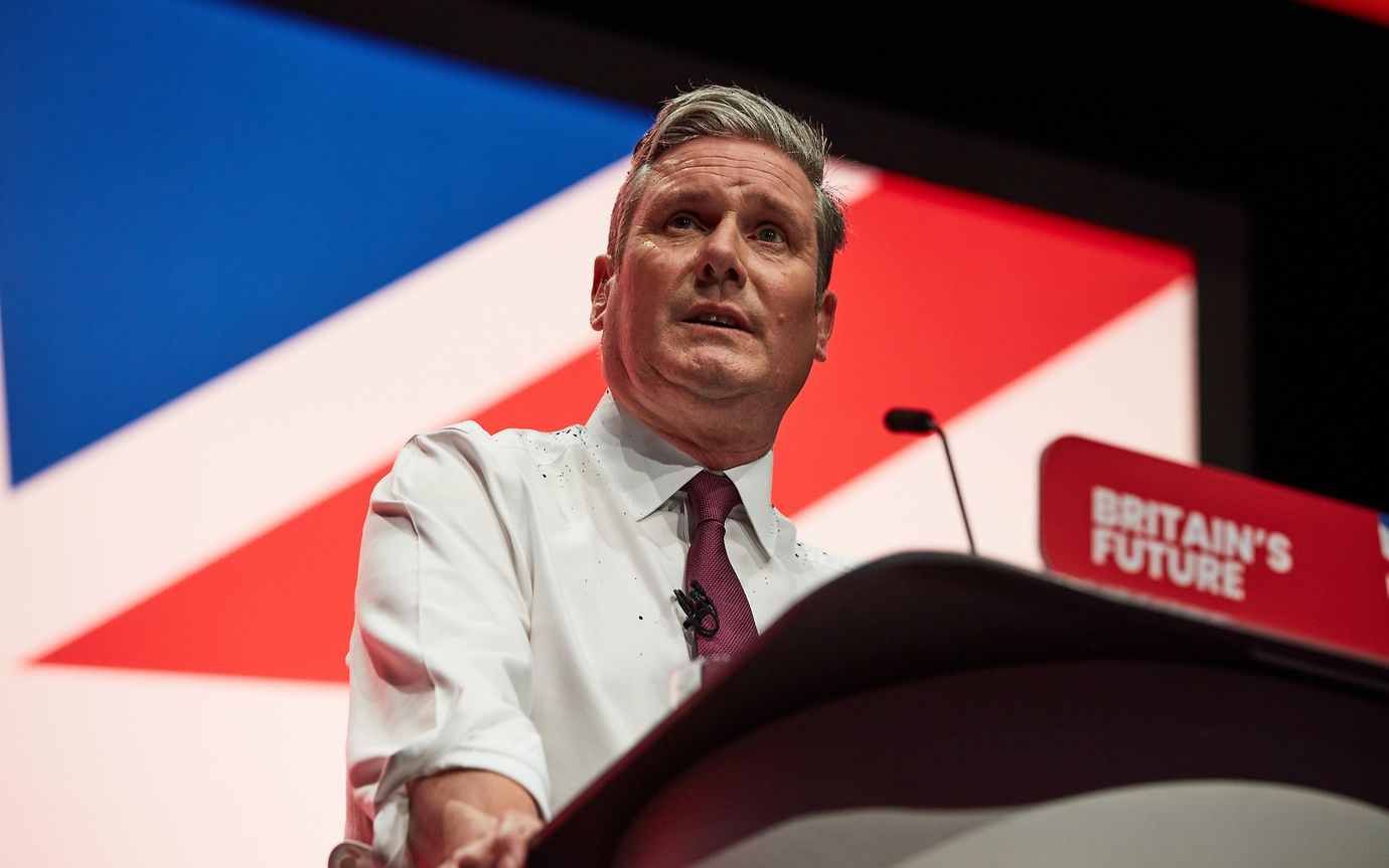 Keir Starmer stands at a podium to give a speech