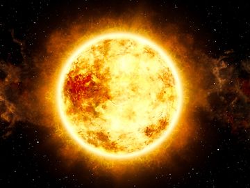 The sun is a mighty ball of energy in glistening yellow and shades of red, floating in black space.