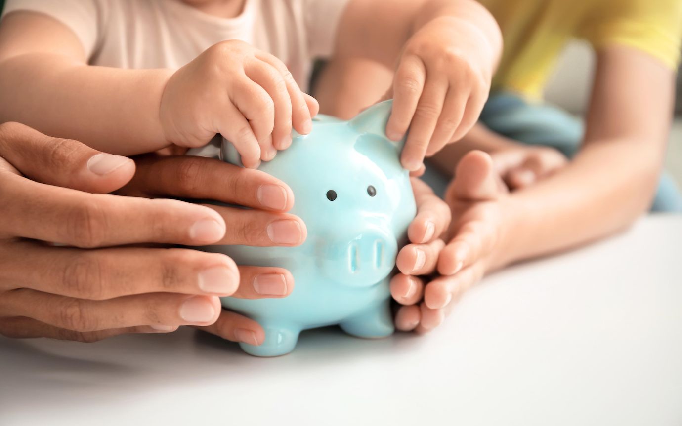 Family with piggy bank at a table